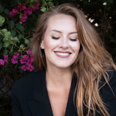 Photo of Mary Margaret Kunze, woman with long blond hair closing her eyes and smiling