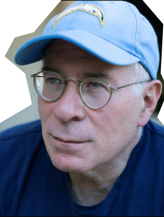 Photo of Andy Wolk, a white man with glasses wearing a light blue baseball cap.