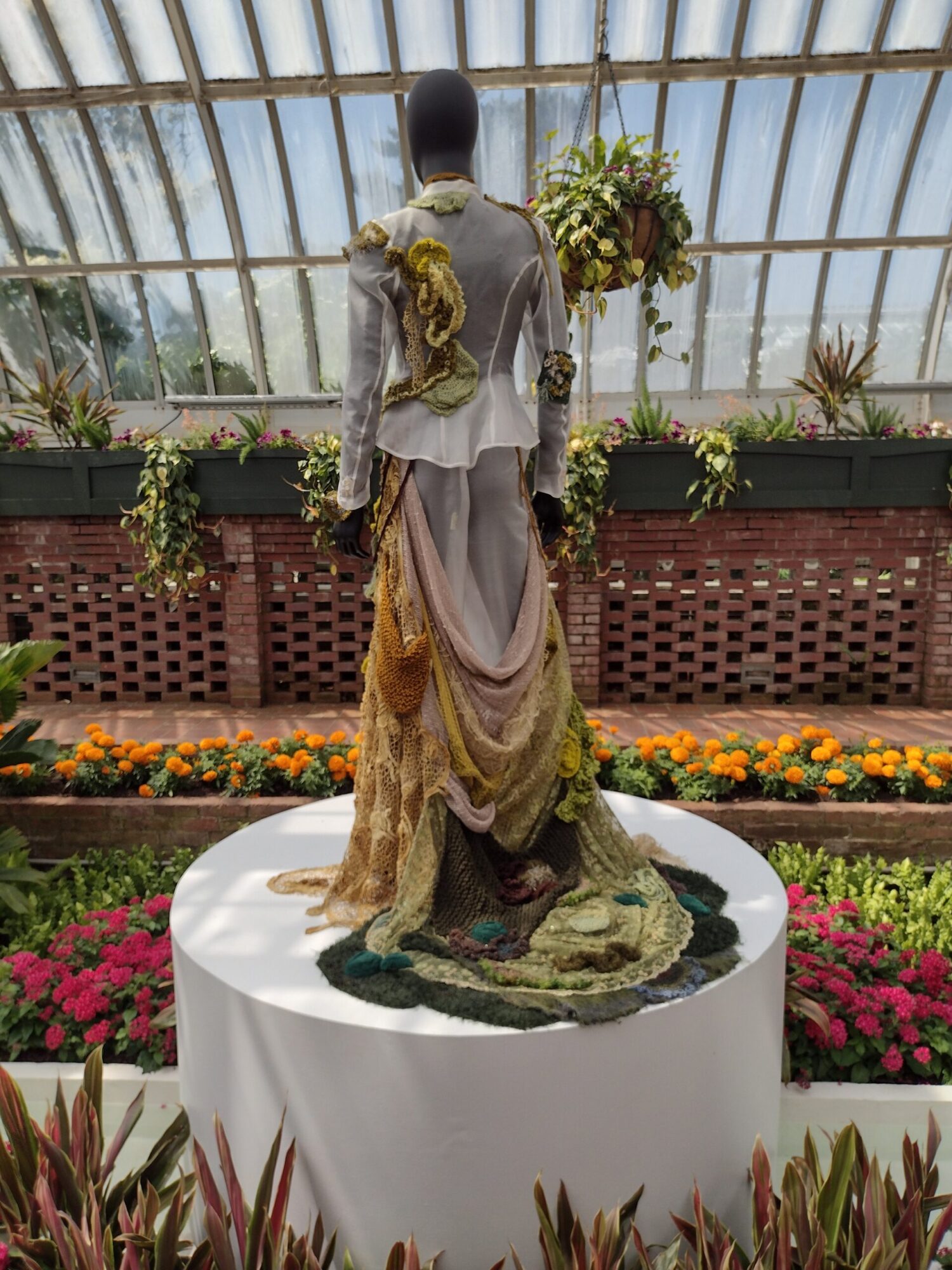 A costume dummy dressed in a floral costume, inspired by Billy Porter, on display at Phipps Conservatory and Botanical Gardens.