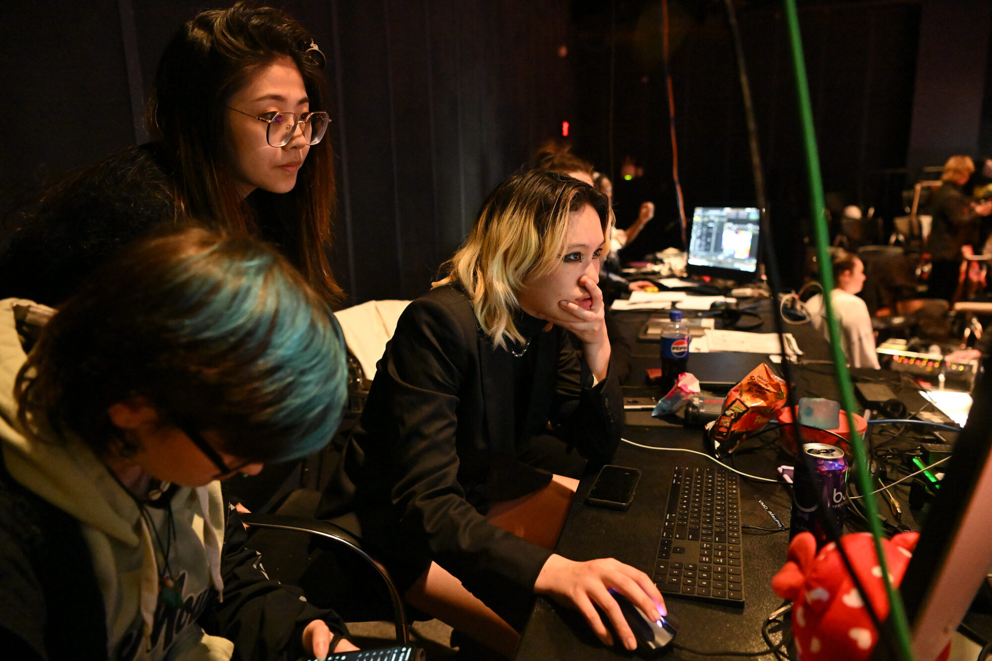 Students working on a computer in a theater during a technical rehearsal