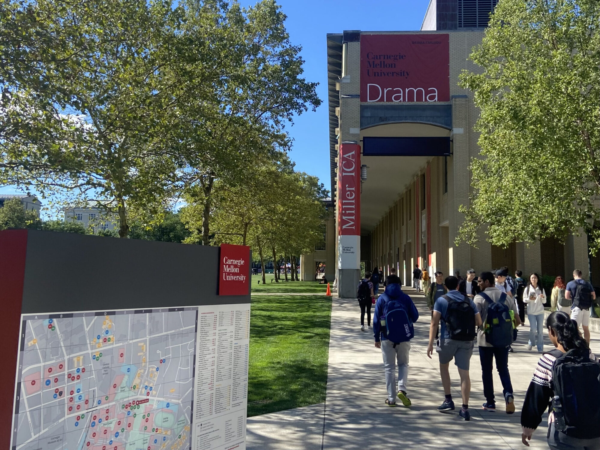 Exterior shot of Purnell Center for the Arts, a large red banner at the top of the building says “DRAMA”