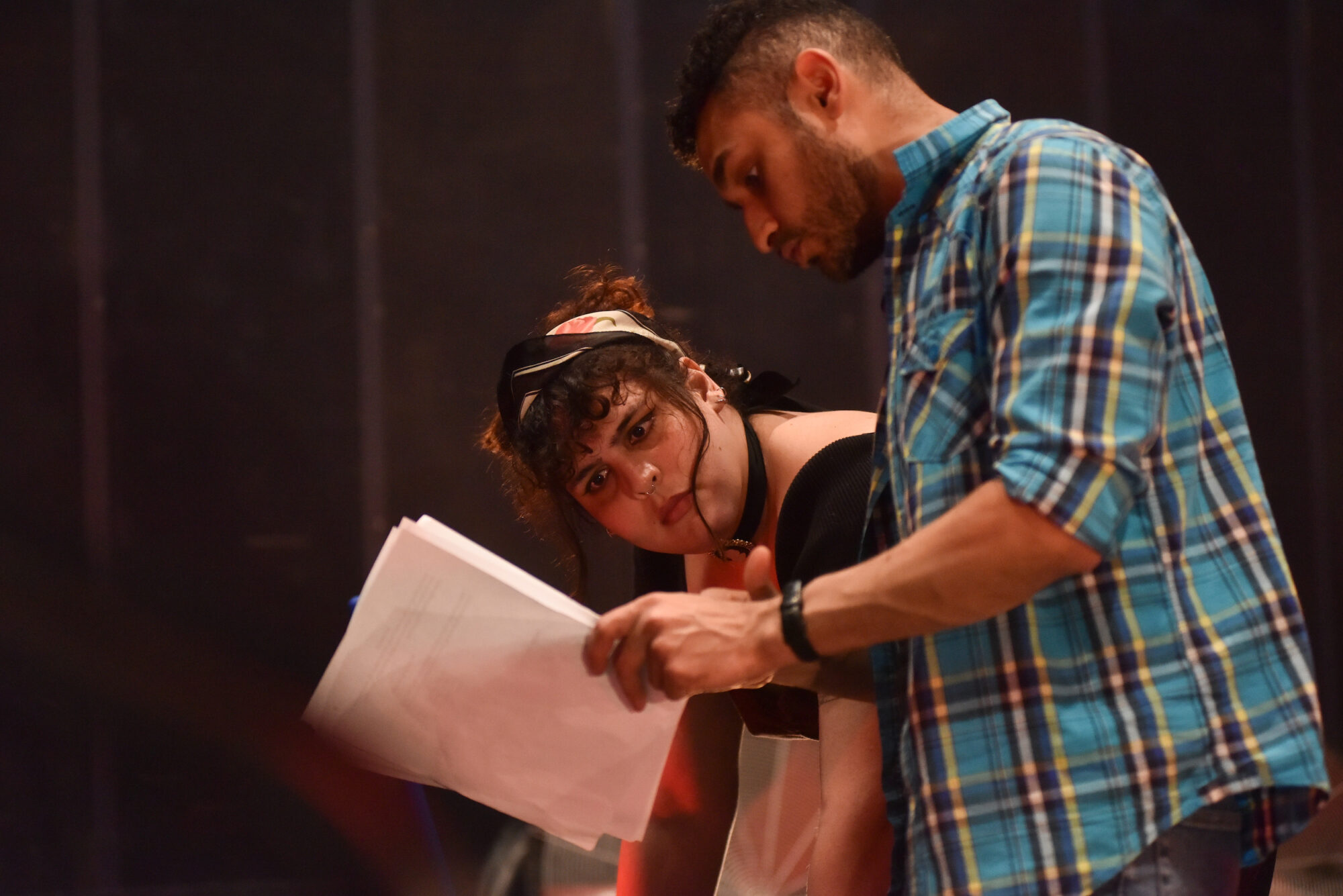 Two people looking at a script.