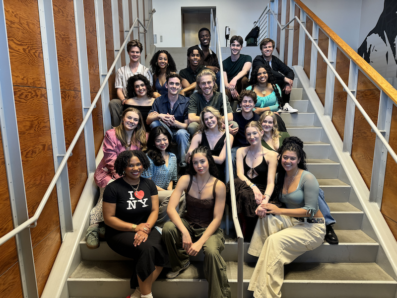 Acting/MT Class of 2024 sitting on the staircase of Signature Theatre in NYC.