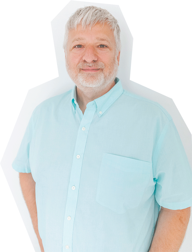 Photo of David Boevers, a white man with white short hair, wearing a light blue, short-sleeved, button up shirt.