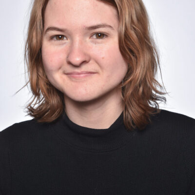 Photo of Bridget Doherty, a woman with short strawberry blonde hair, wearing a black shirt.