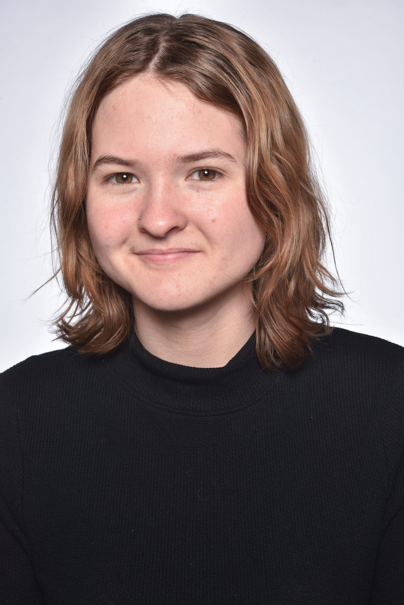 Photo of Bridget Doherty, a woman with short strawberry blonde hair, wearing a black shirt.