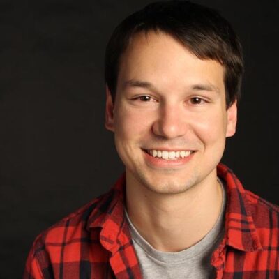 Photo of Bryce Cutler, a white man with brown hair wearing a red flannel shirt and smiling.