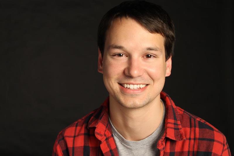 Photo of Bryce Cutler, a white man with brown hair wearing a red flannel shirt and smiling.