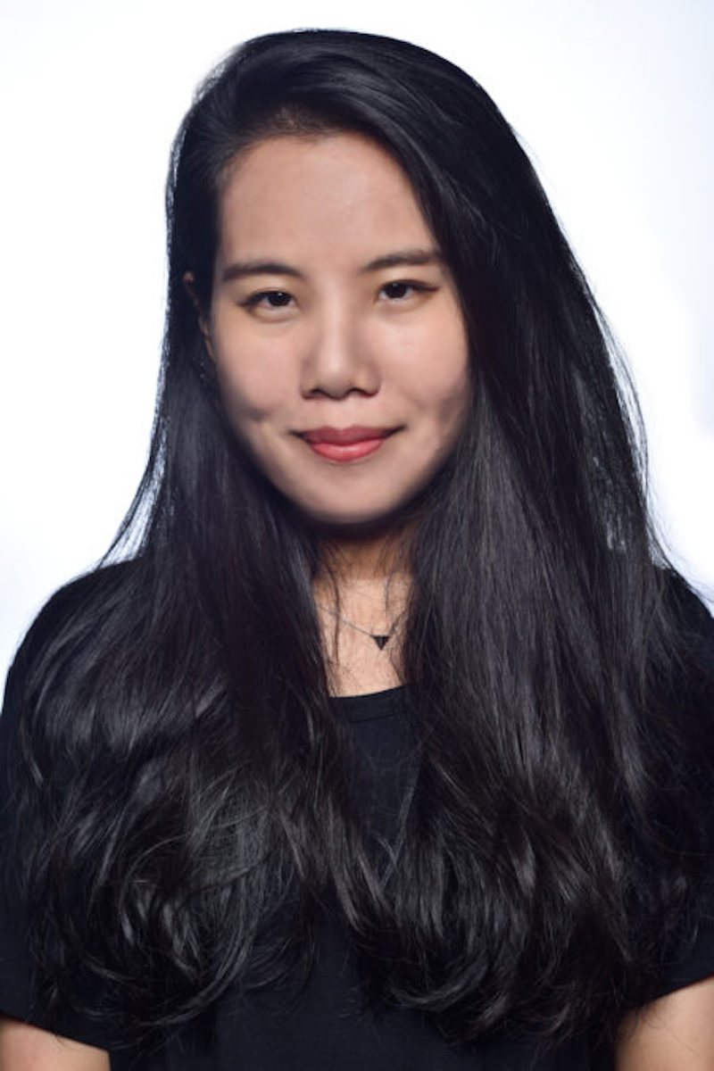 Photo of Chen-Wei Liao, a woman with long black hair wearing a black shirt.