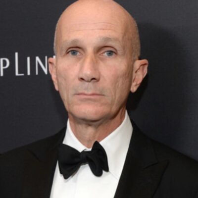 Photo of Daniel Orlandi, a white man with a bald head wearing a tuxedo and bowtie.