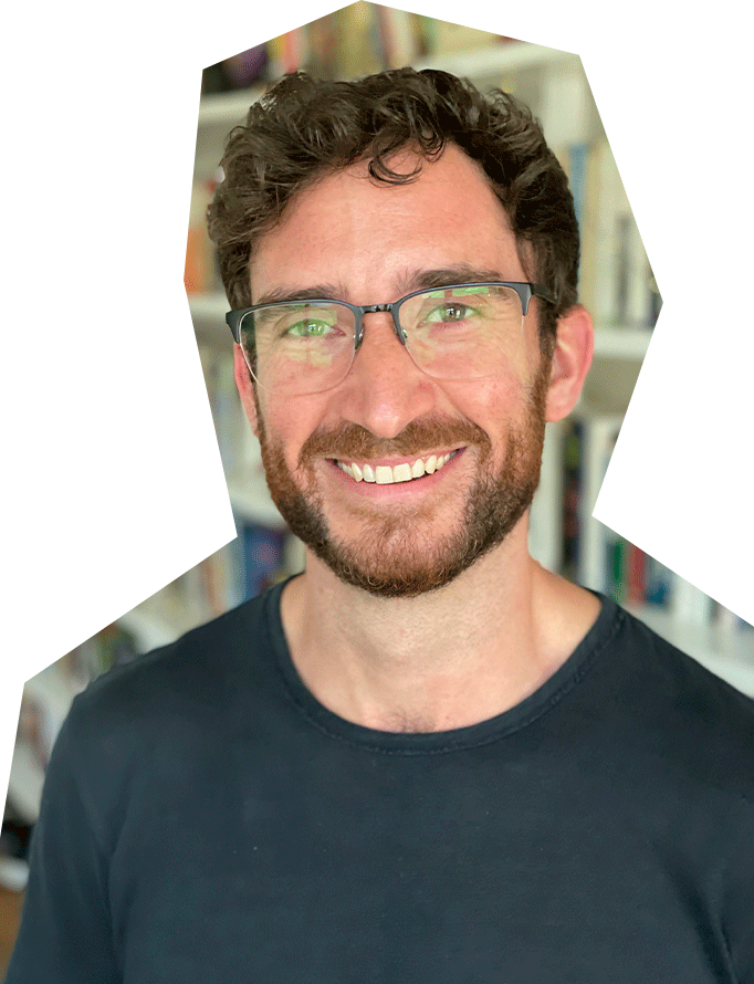 Photo of Andrew Dunn, a white man with brown hair and glasses, wearing a dark t-shirt and smiling.