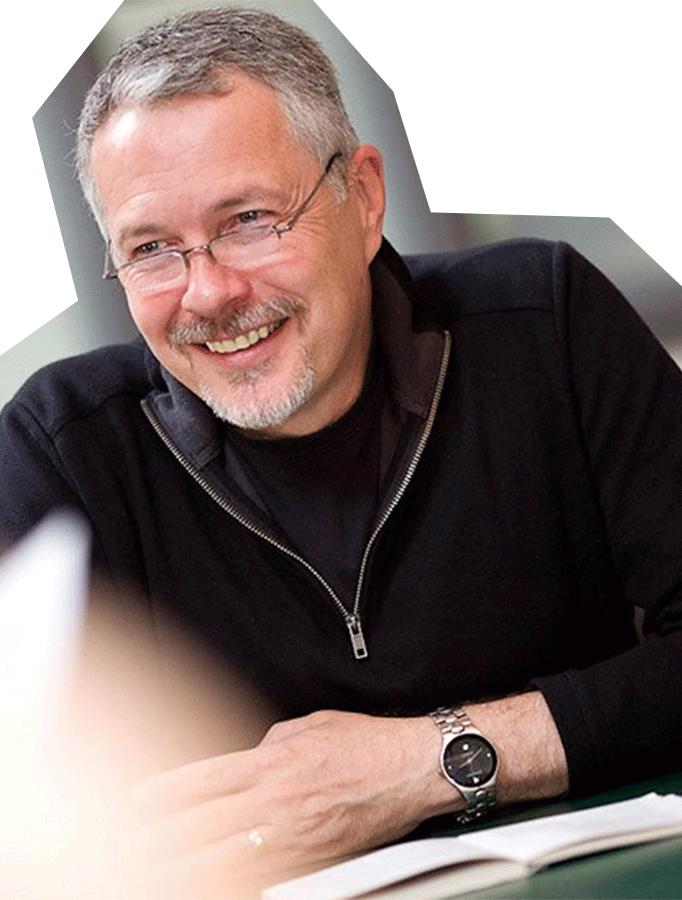 Photo of Gary Logan, a white man with gray hair and glasses, wearing a black shirt.