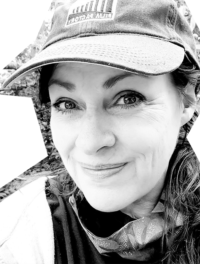 Black and white photo of Melissa Martin, a white woman wearing a cap and smiling.