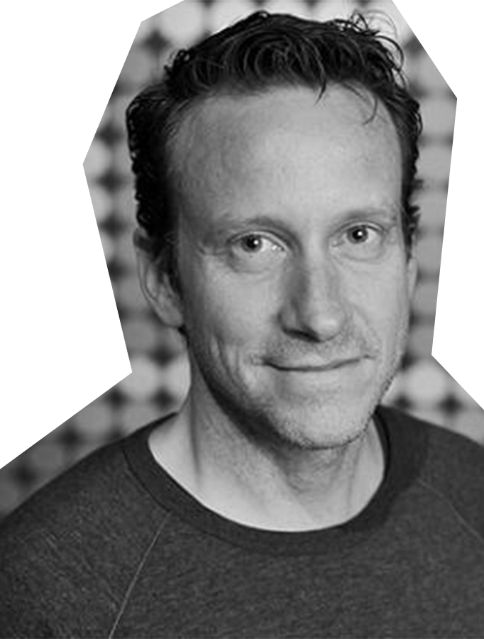 Black and white photo of Lawrence Shea, a white man with brown hair, wearing a dark t-shirt.