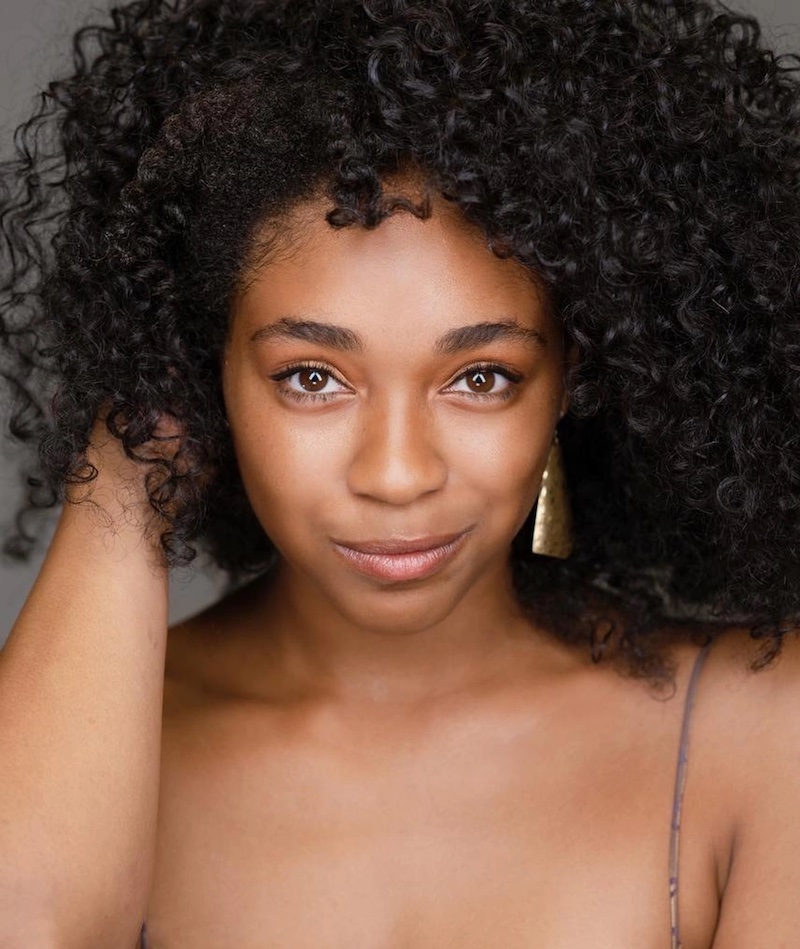 A photo of Simone Joy Jones, a black woman with black curly hair.