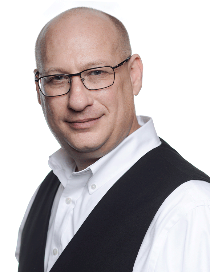 Photo of Louis Stein, a white man with a bald head and glasses, wearing a white collared shirt and black vest.