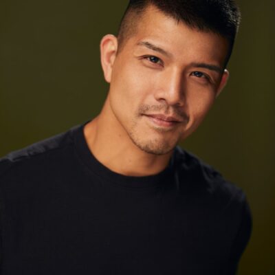 Photo of Telly Leung - a man wearing a dark crewneck shirt.