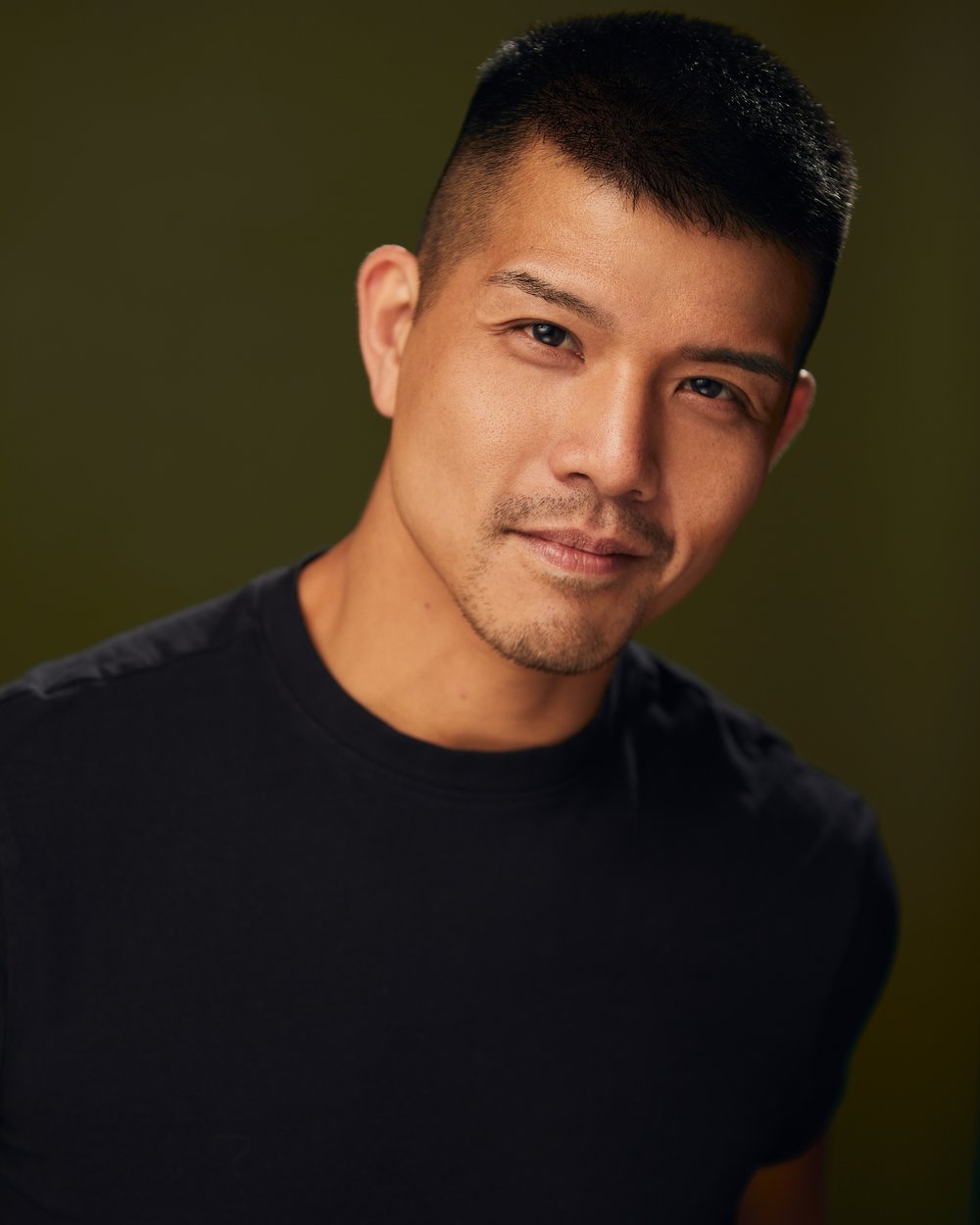 Photo of Telly Leung - a man wearing a dark crewneck shirt.