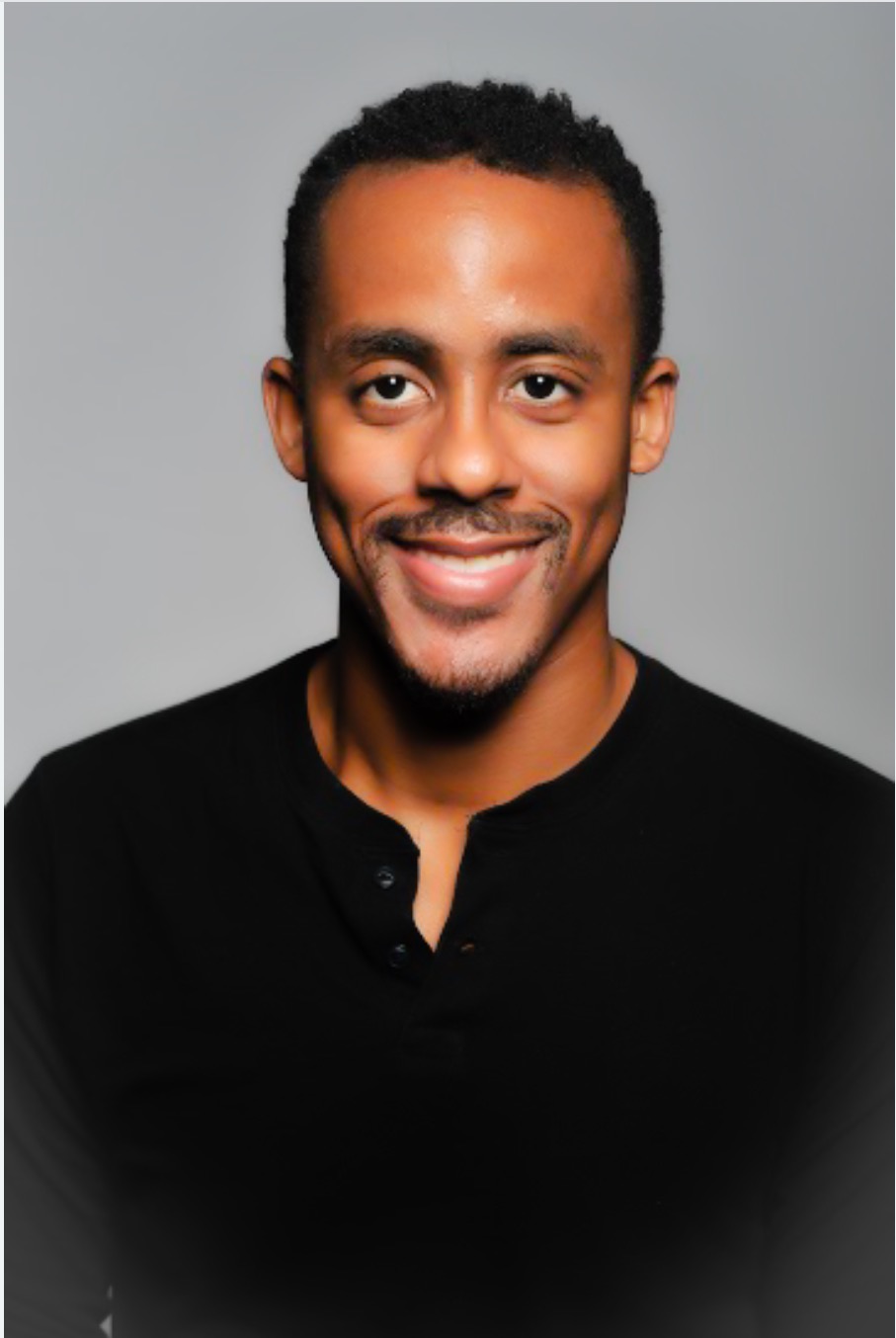 Photo of Leviticus Jelks, a man with black hair , wearing a black shirt and smiling.