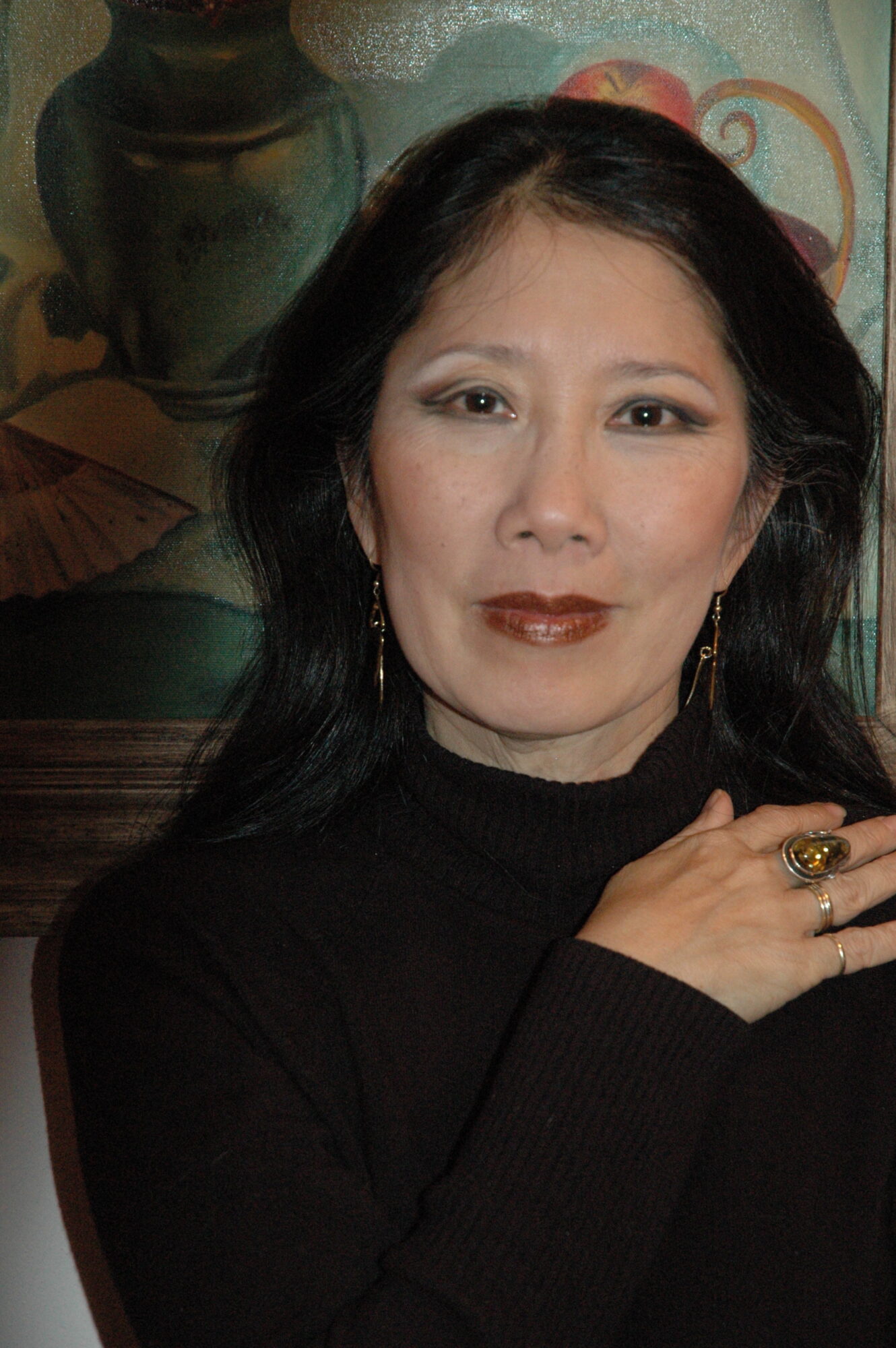 Photo of Susan Tsu, an Asian woman with medium length black hair, wearing a black blouse.