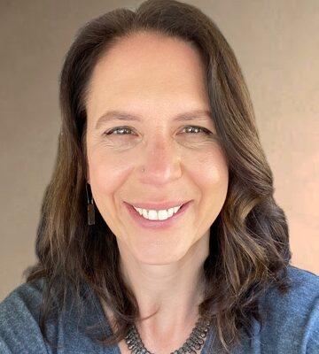 Photo of Jessica Kender, a woman with medium length brown hair, wearing a blue shirt and smiling.