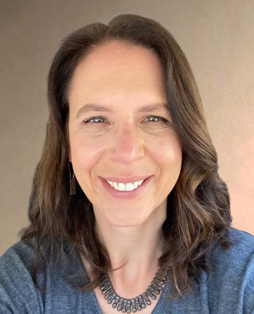 Photo of Jessica Kender, a woman with medium length brown hair, wearing a blue shirt and smiling.