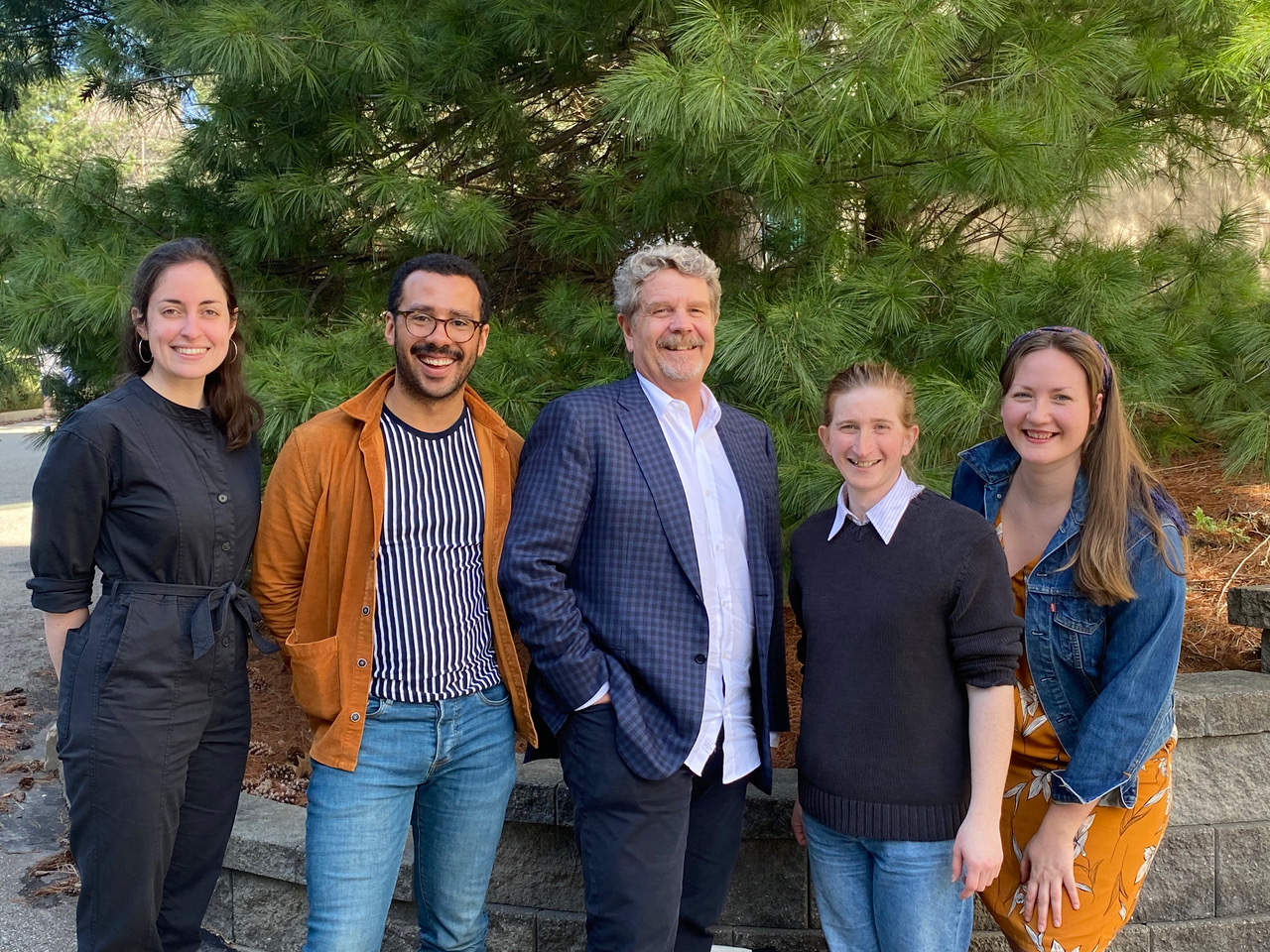 Four directing students stand with John Wells.