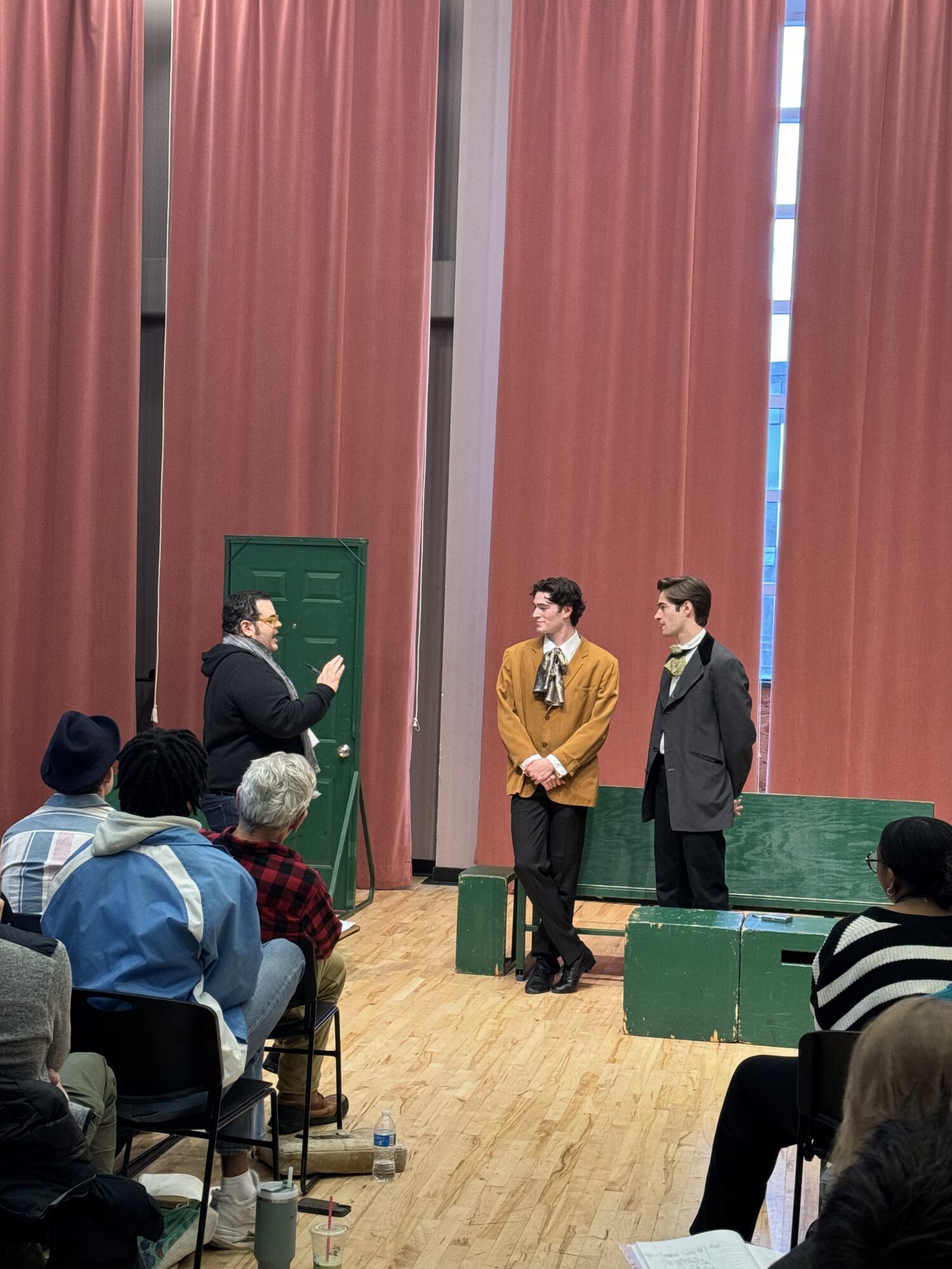 Josh Gad works with students on a comedy scene