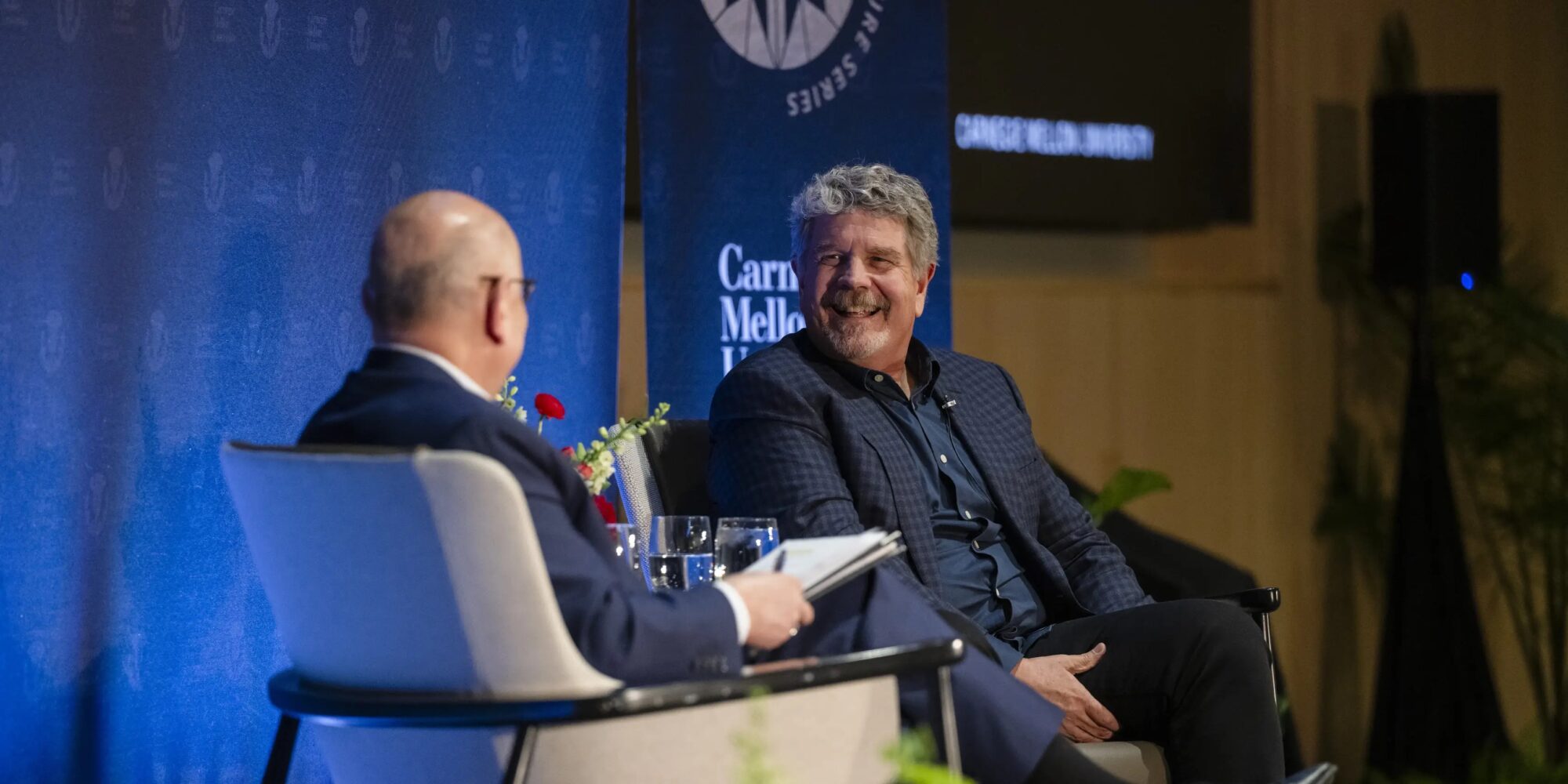John Wells is interviewed on stage by CMU President Farnam Jahanian