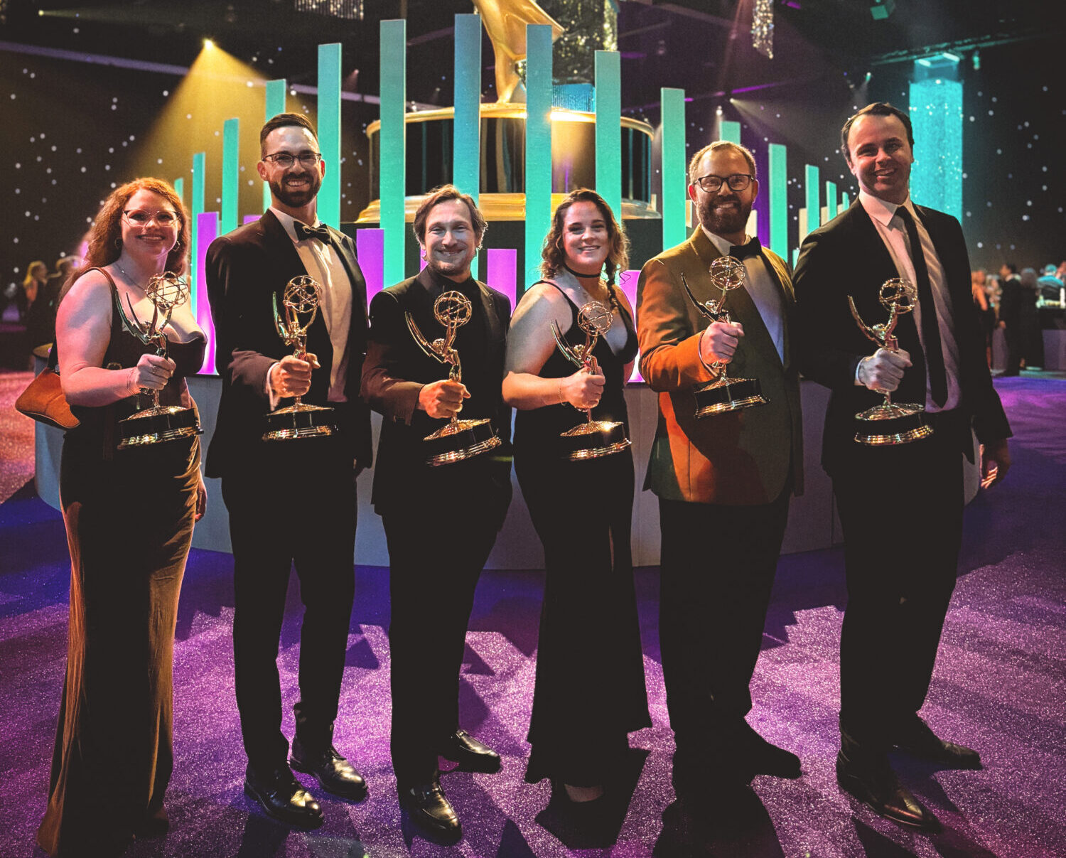 Emmy winners holding their trophies.