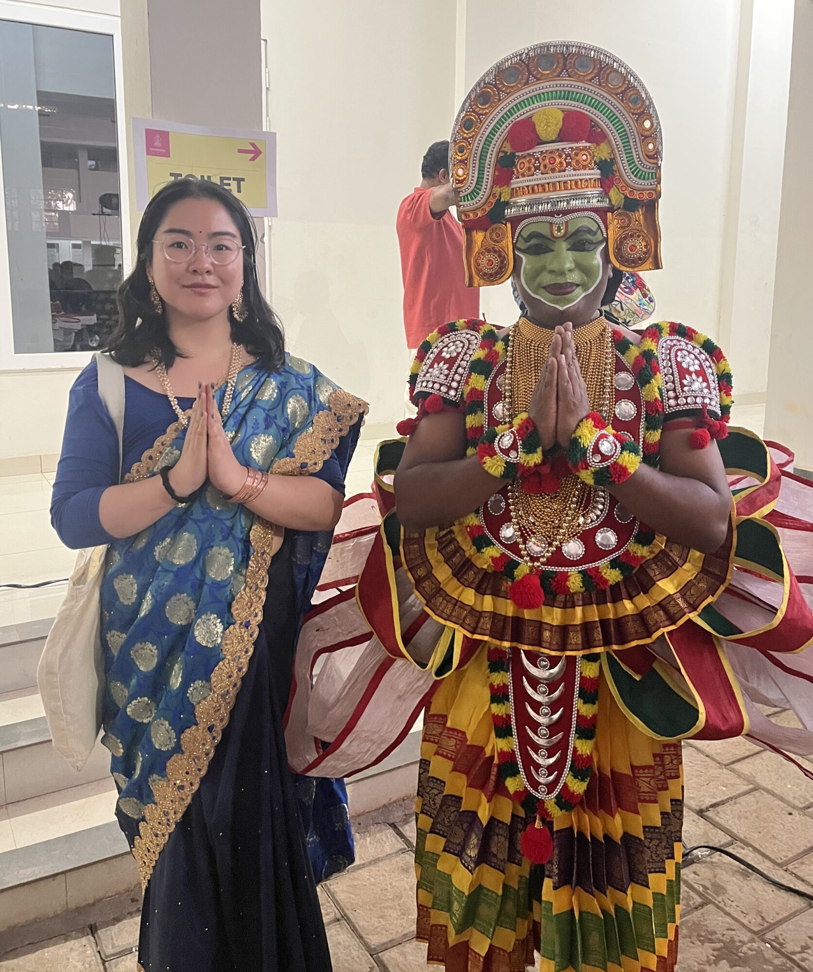 A student with a traditional Indian performer.