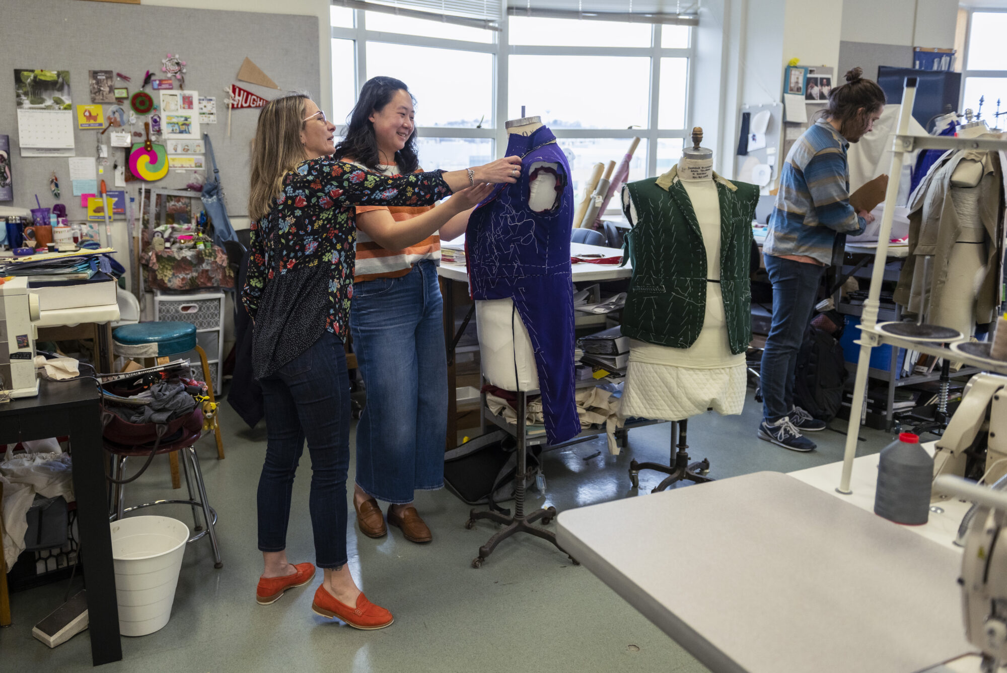 Tiia Lager helps a student in the Costume Studio